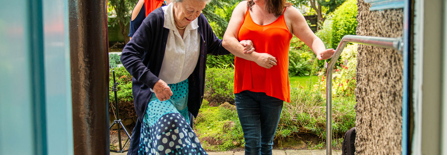 Caregivers helping elderly client