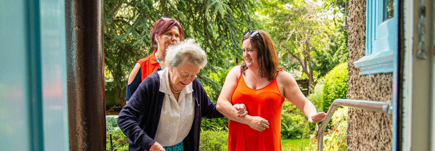 Caregivers helping elderly client