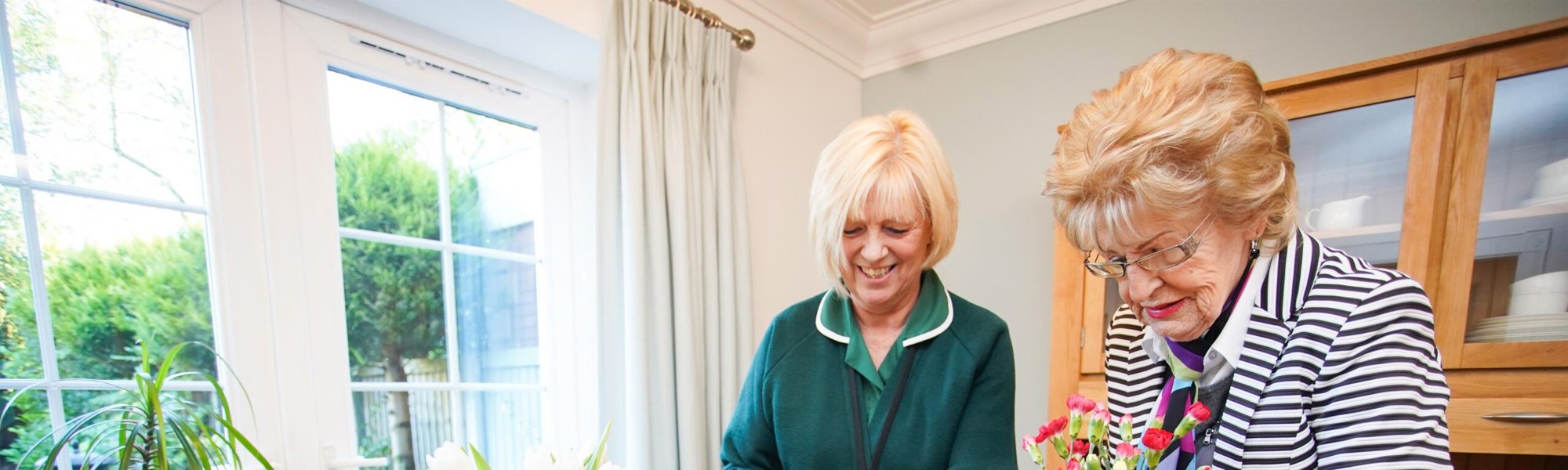 Client and CareGiver arranging flowers