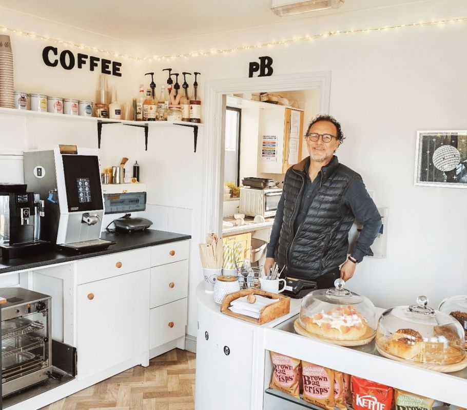 man serving cakes in cafe in long bennington