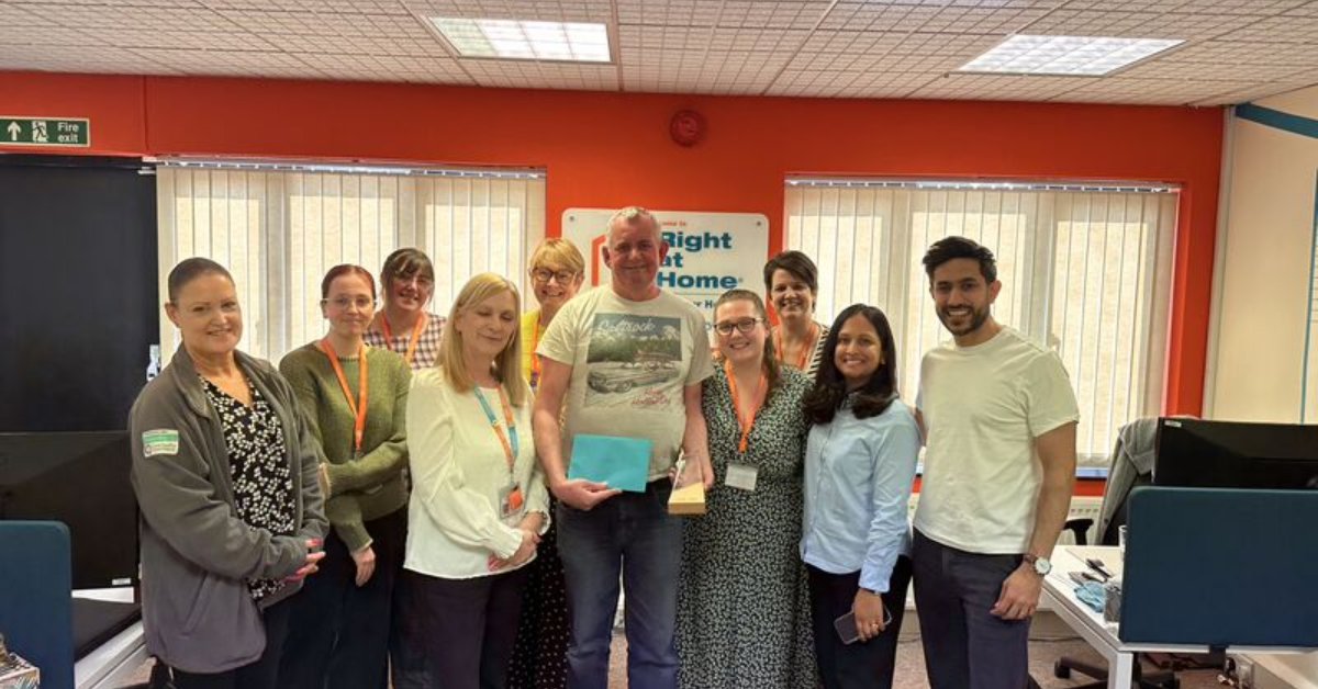 Team members at Right at Home Solent celebrating Fabian receiving his 10-year service award alongside Directors Amy Patel Popat and Kev Popat.