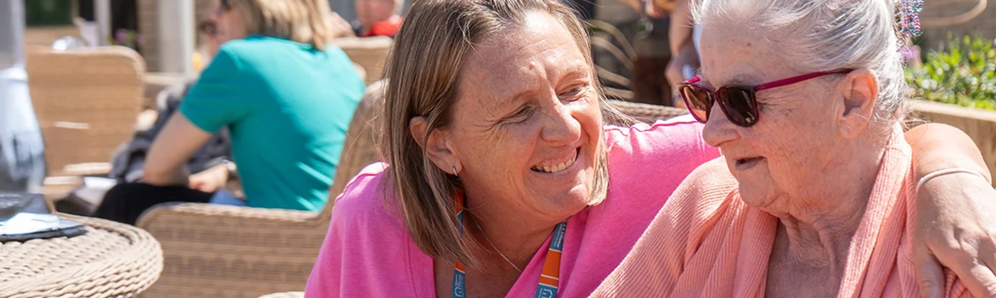 Carer spending time with a client at a local community event