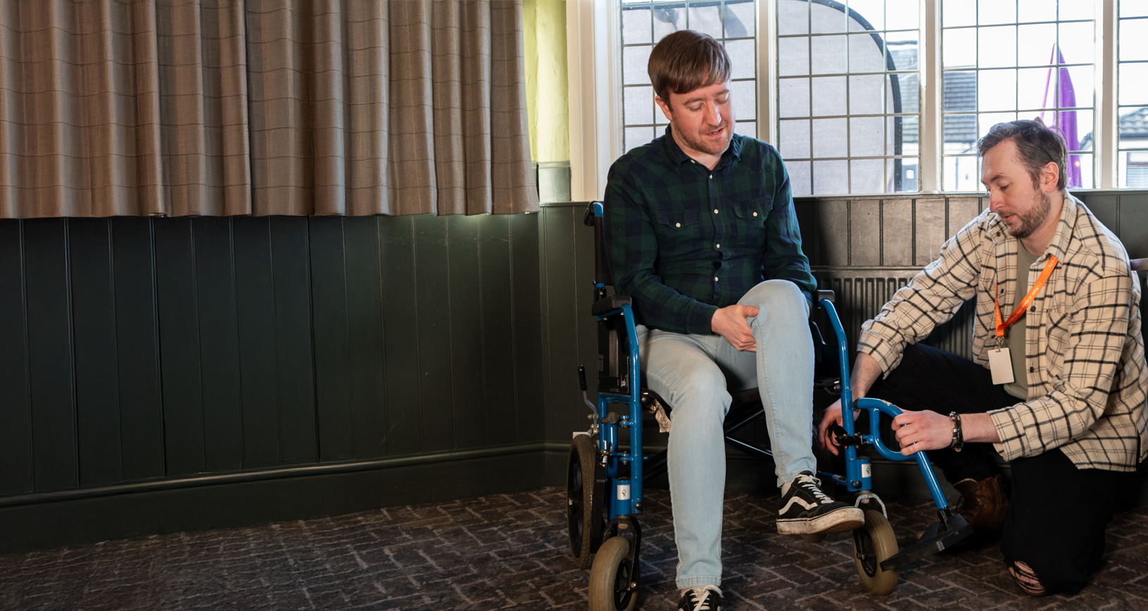 Care Assistant helps Client with his wheelchair