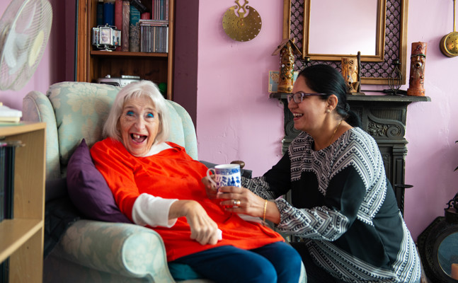 Client and CareGiver talking and smiling 