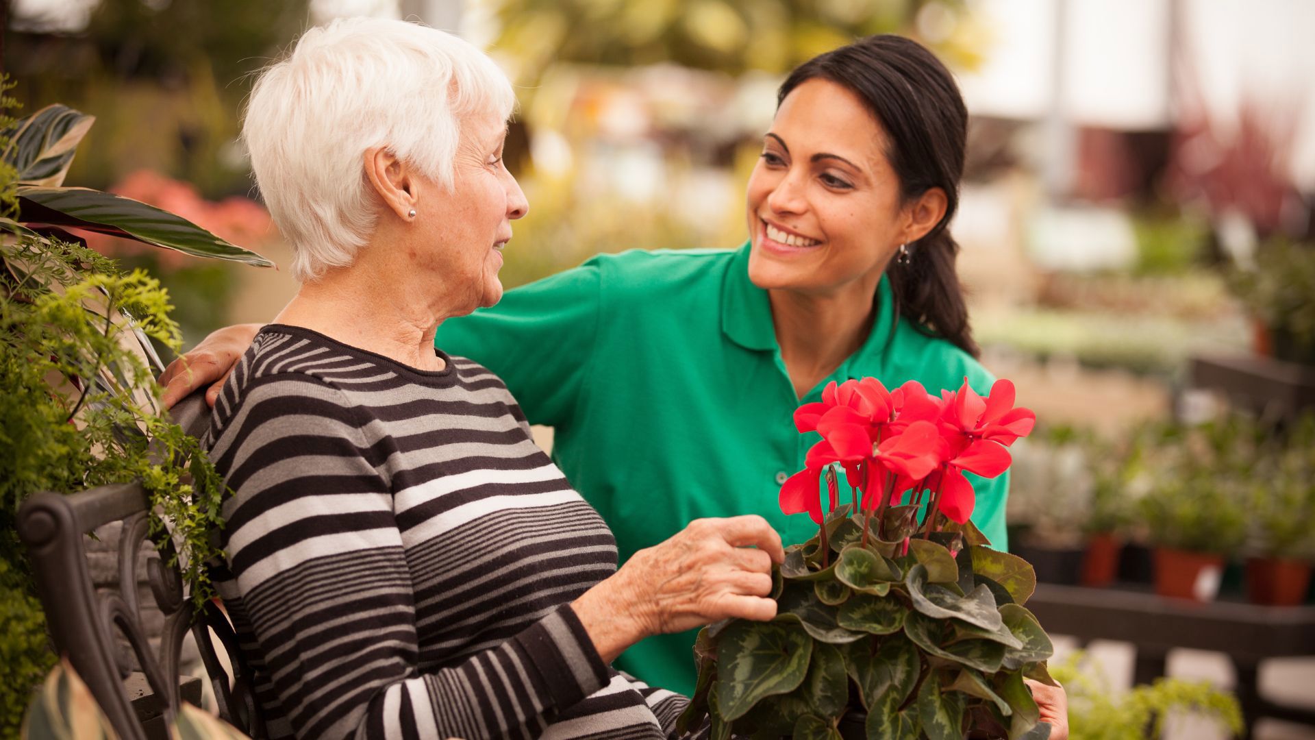 homecare client and caregiver chatting on bench