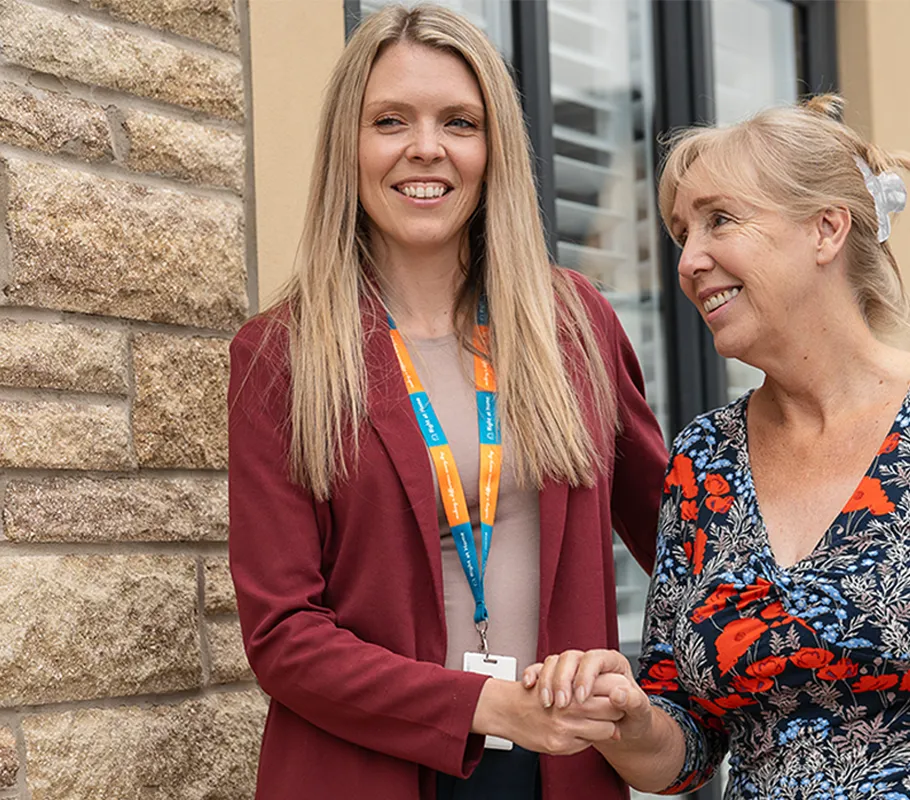Client and Carer enjoying a walk around the garden