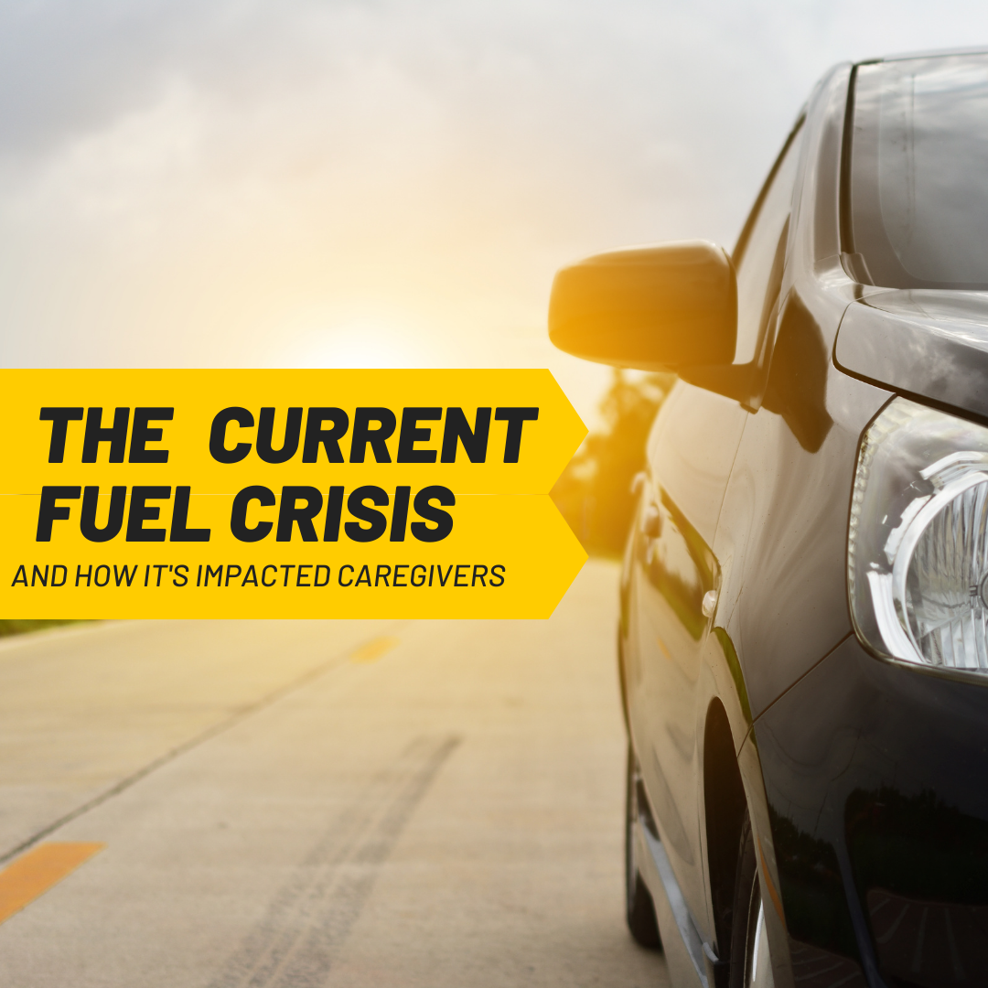 Black car on road with sun setting behind