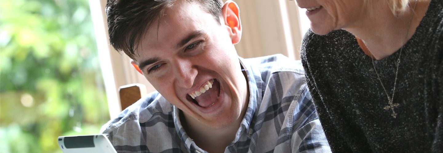 Man laughing with Woman using ipad