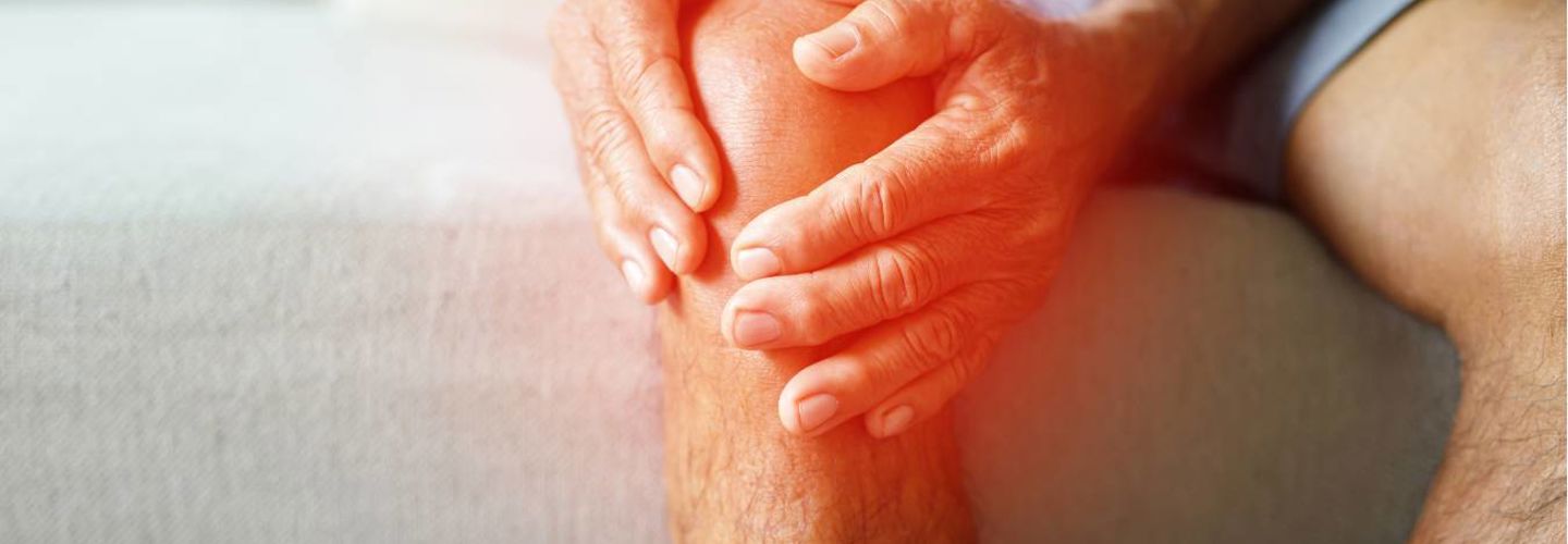man-holding-his-knee-in-pain-living-with-osteoarthritis
