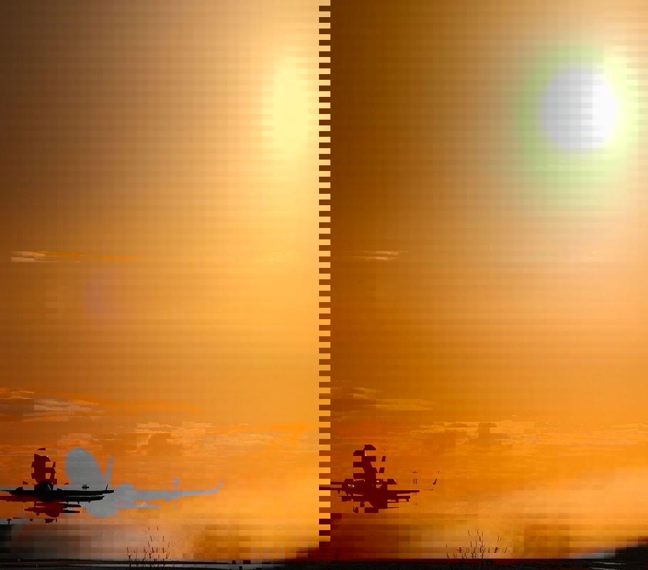 plane taking off from Leeds airport at sunset