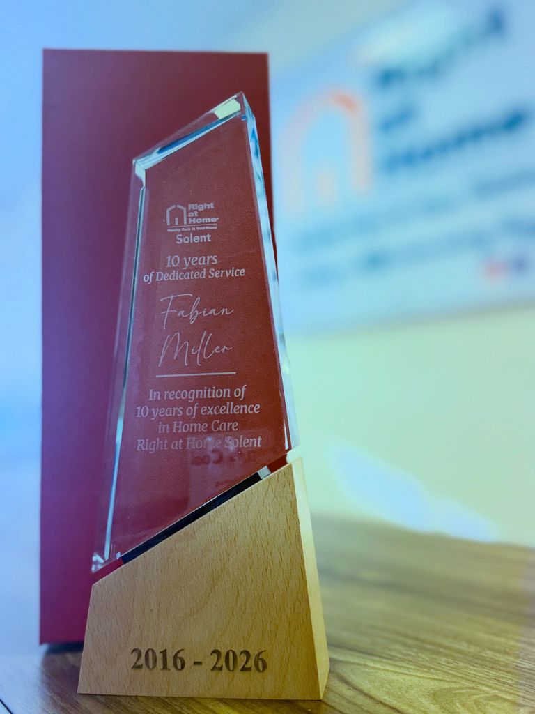 Close-up of the 10-year service award trophy presented to Fabian in recognition of his dedication to home care support.