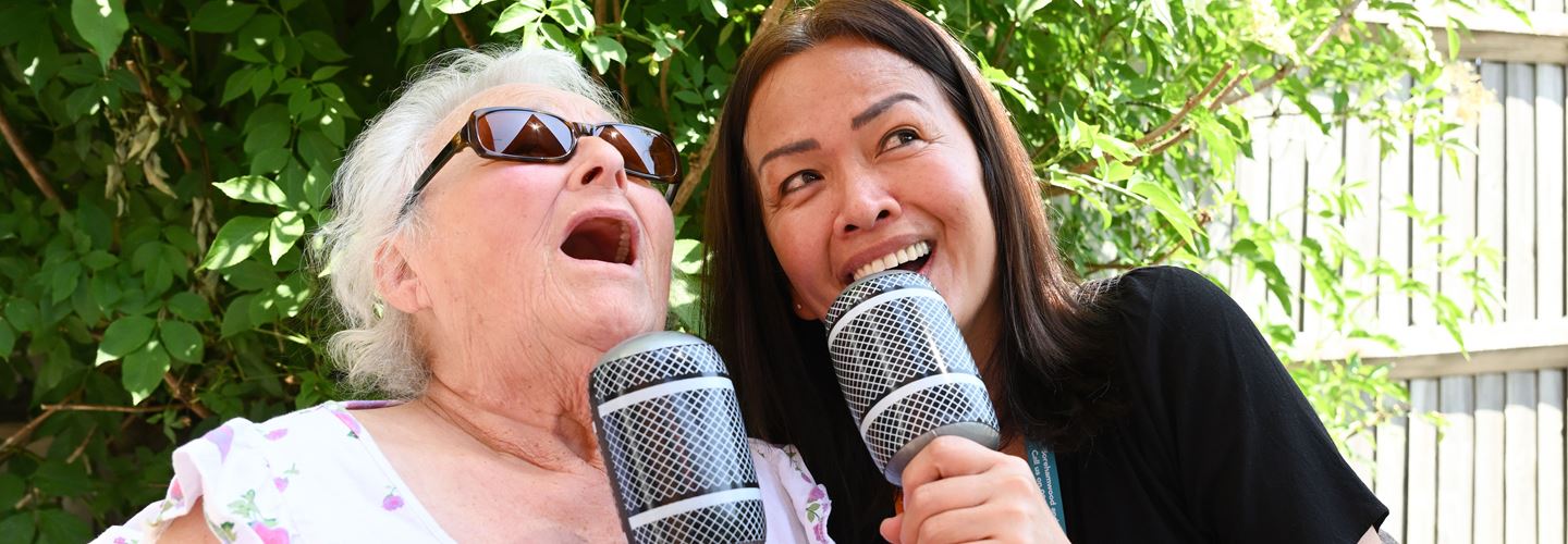 Companion_CareGiver_Singing_With_Client_Outside_Garden