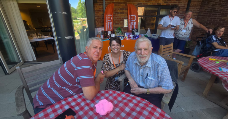 Two clients smiling with a member of the Right at Home Southampton office team at the Big Green Picnic.