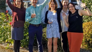 Group of people celebrating and looking happy.