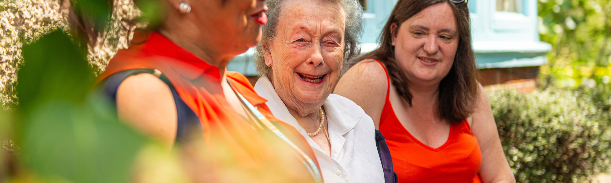 Client laughing in a garden