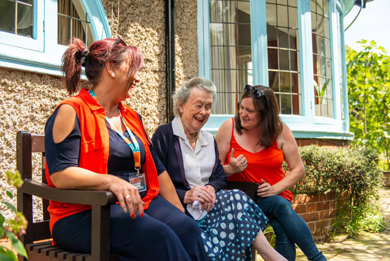 CareGivers and client talking on a bench